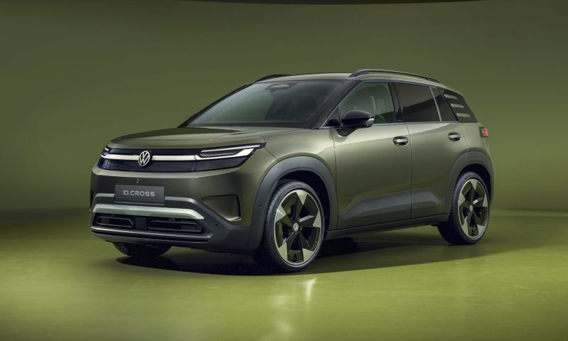 A photograph of a green Volkswagen ID. Cross SUV on a green studio background